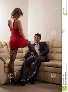 Full length portrait of couple flirting in living room.