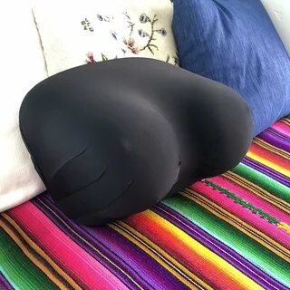 breast pillow black spandex on striped rug and pillows.jpg.