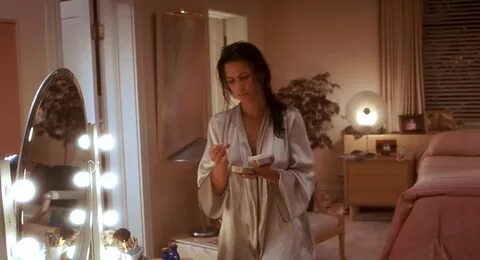 Hollow man is watching Rhona Mitra moisturizing herself. 