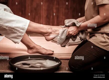 Closeup of legs, woman having a massage in spa salon Stock Photo. 
