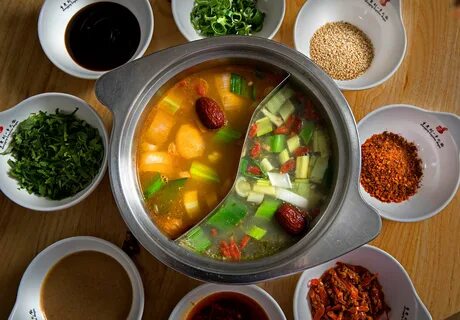 The hot pot: a pot of seasoned broth and/or oil that cooks meat, leafy vege...