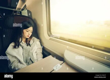 Business trip Asian woman working on laptop on train commute travel lifesty...