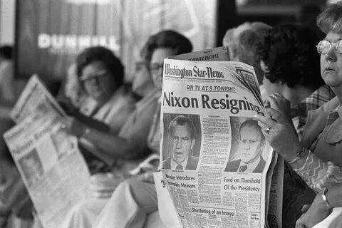 He is reading a newspaper now