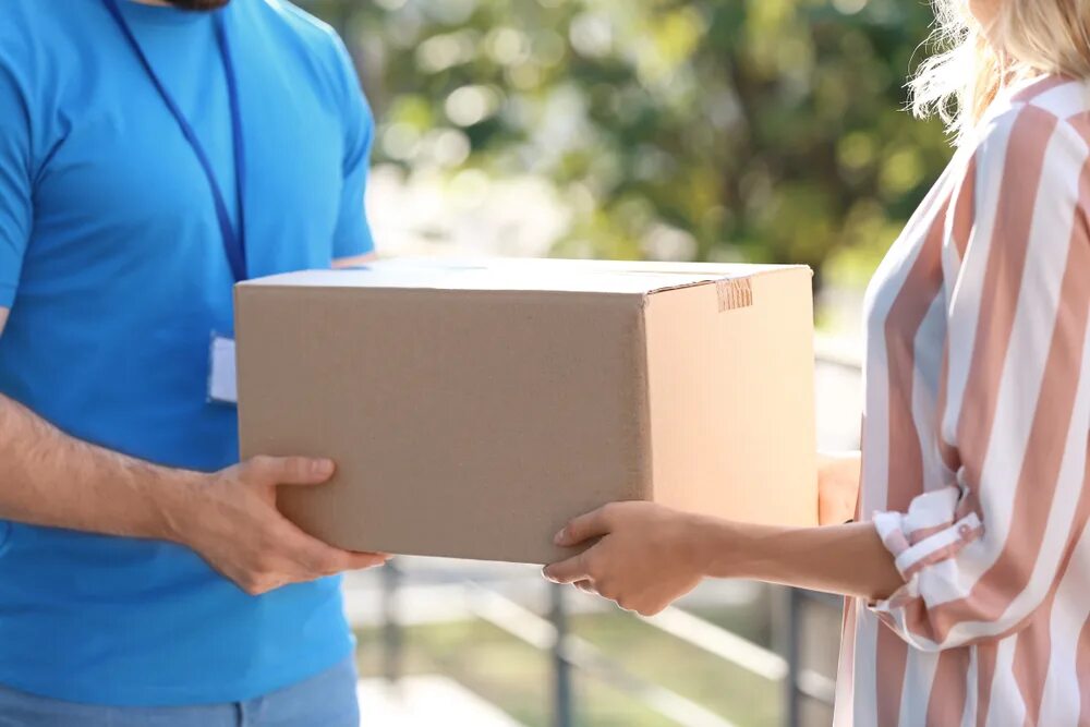 Receiving a parcel. Women parcel. Woman receiving delivery. Woman receiving parcel with.