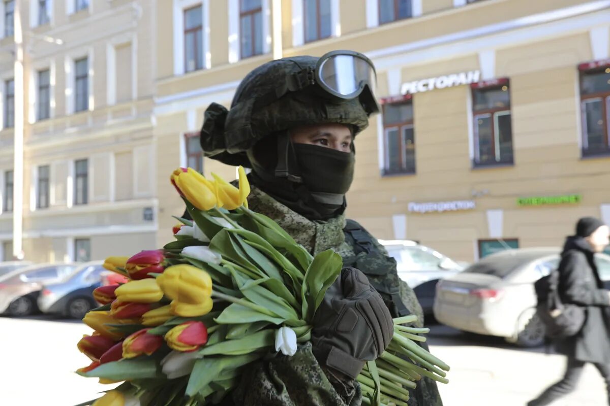 В преддверии международного женского дня 8. Спецназ дарит цветы. Спецназовец с цветами. Военный с букетом.