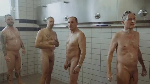 Naked men in showers.