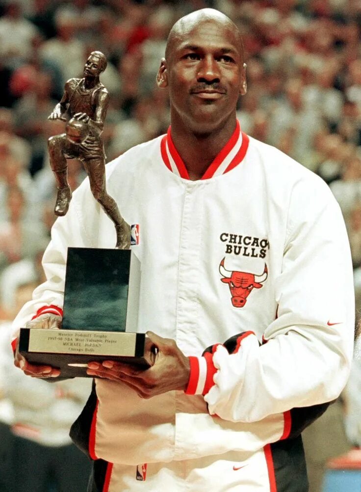 Michael Jordan of the Chicago Bulls poses with the trophy after... Basketball sa