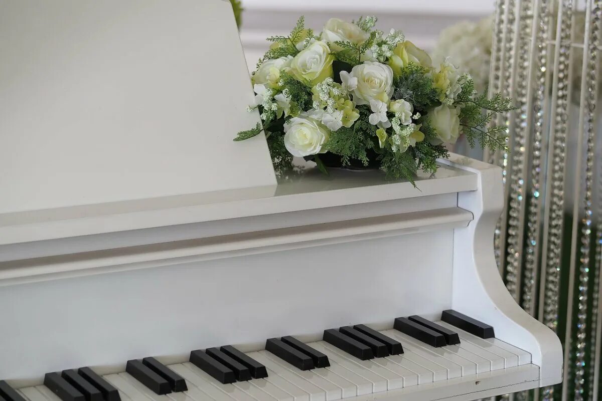 Клавиши белого рояля. Красивое пианино. Красивый рояль. Рояль с цветами. Фортепиано.