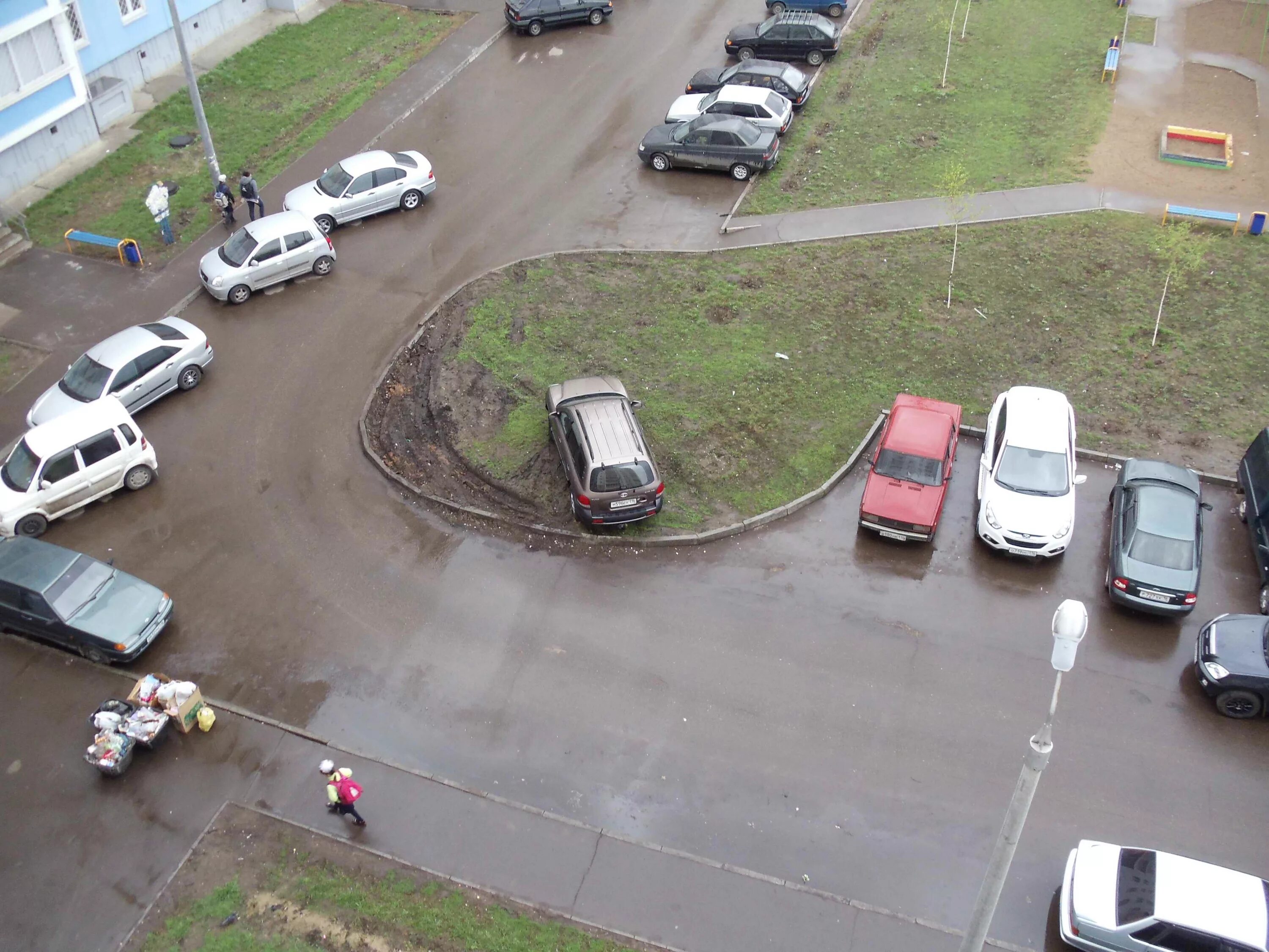 Движение машин во дворах. Парковка во дворе. автомобиль припаркован на детской площадке. машина на парковке. стоянка на газоне.