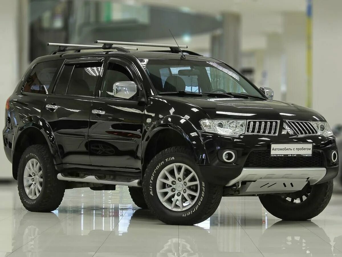 Mitsubishi pajero sport расход. Pajero Sport 2012. Mitsubishi Pajero Sport 2012. Митсубиши Паджеро спорт 2012. Mitsubishi Pajero Sport черный 2012.