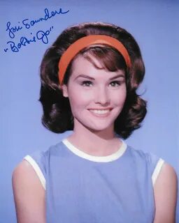 an old photo of a woman wearing a headband.