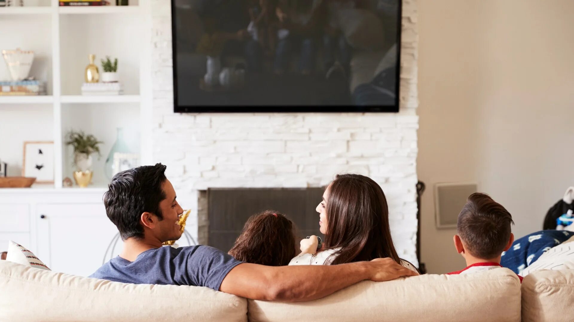Муж смотрит новости. Семья в гостиной. Семья у телевизора. Семья смотрит телевизор.