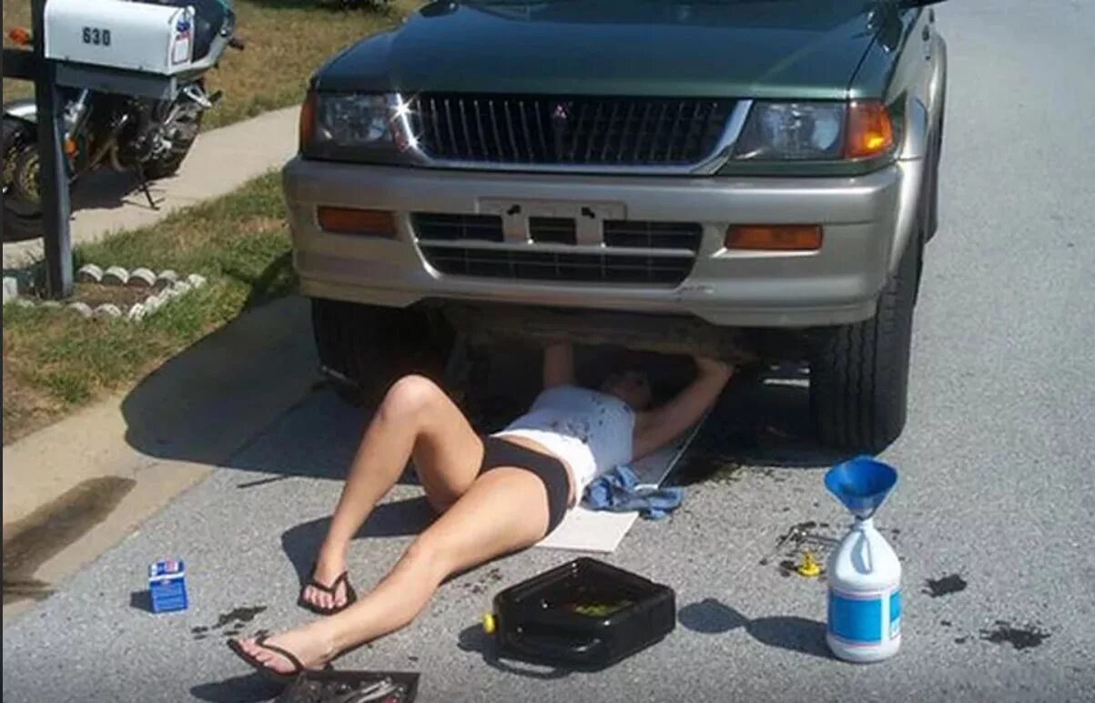 Парень починил девушке машину. Женщина под машиной. Девушка под машиной ремонтирует. Баба под машиной. Женщина чинит машину.