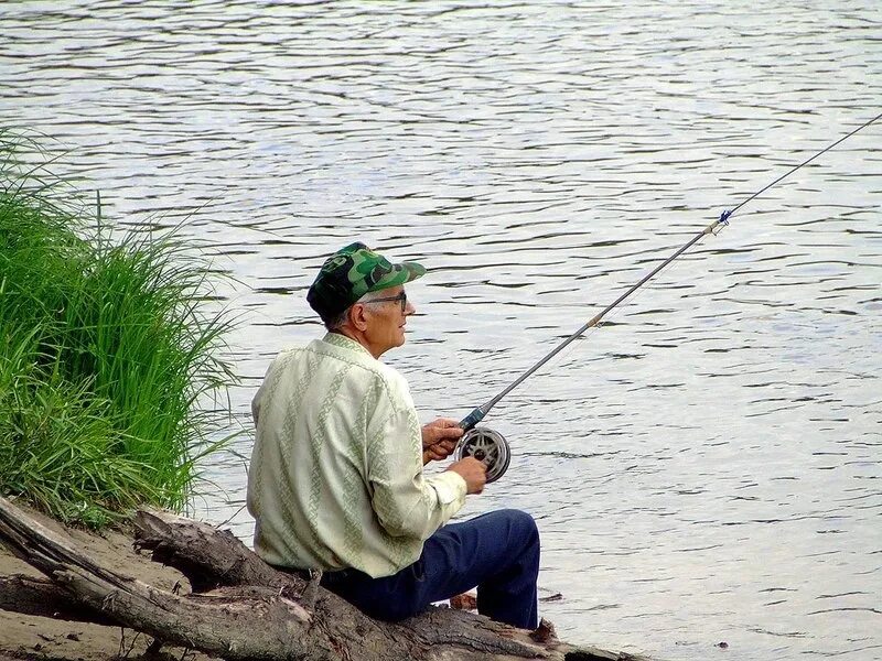 Здесь ловят рыбу. Дедушка с удочкой. Старик с удочкой. Старик на рыбалке. Дед рыбачит.