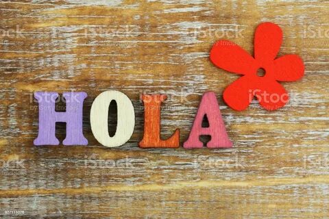 Hola written with colorful wooden letters and red flower - Сток картинки.