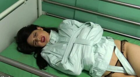 Yasmine - Green Straitjacket on a Bondage Bed at - Download or watch online...