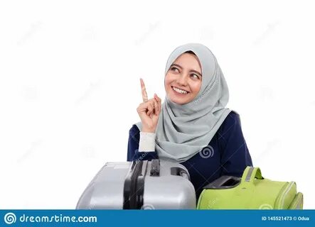 Asian muslim woman with hijab pointing up to copy space over white. 