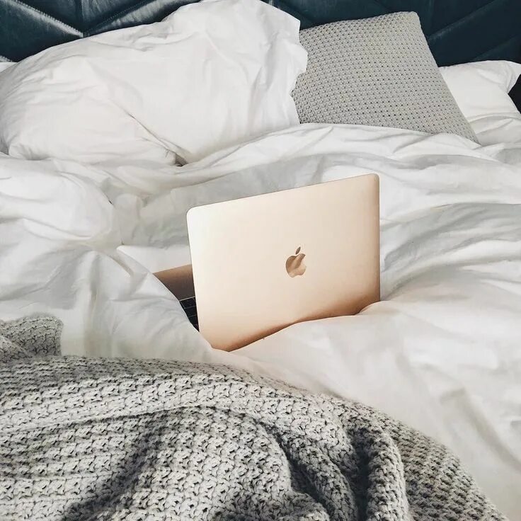 Apple Laptop on Bed with Blankets