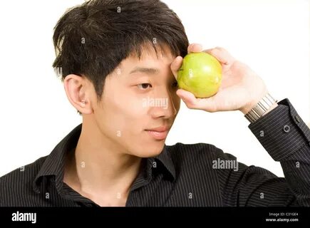 Young Asian man eating apple Stock Photo - Alamy