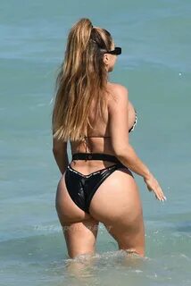 Larsa Pippen shows off her famous curves in a unique belted bikini that say...