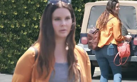 Lana Del Rey sports an orange windbreaker as she leaves a golf course in Lo...