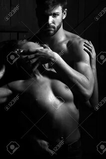 macho man touching and embracing passionate pretty woman with body and brea...