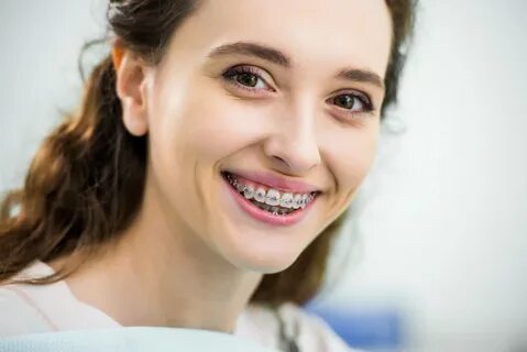 patient with braces in Tamarac smiles.