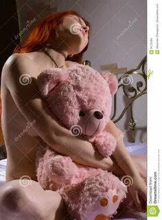 Young Woman Lying On A Bed And Kissing Teddy Bear Stock Photo - Image of fa...