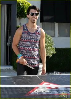 Nick and Joe Joe Jonas playing ping pong.