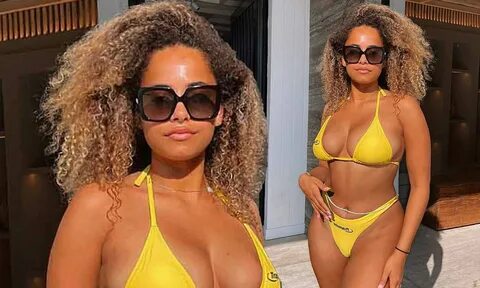 Love Island star Amber Gill displays her curves in a tiny a canary yellow b...