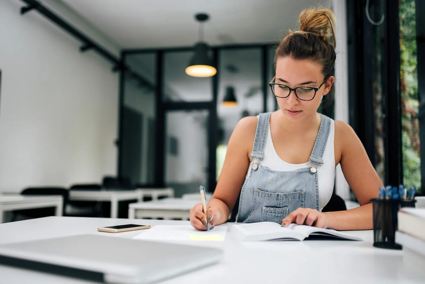 Находчивая женщина Shutterstock. ISO image writer. A student is writing an essay.