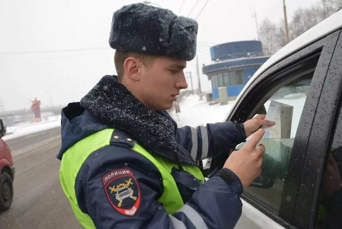 Сотрудник ГИБДД. Сотрудник ГАИ. Сотрудник ГИБДД проверяет документы. Дорожная полиция. Сотрудник дпс остановил для проверки документов