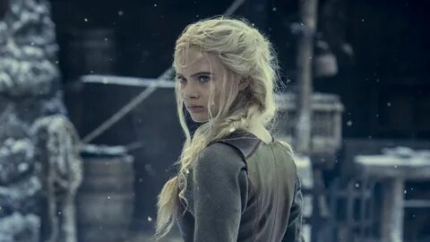 Ciri in The Witcher season 2, standing outside in the snow, looking over he...