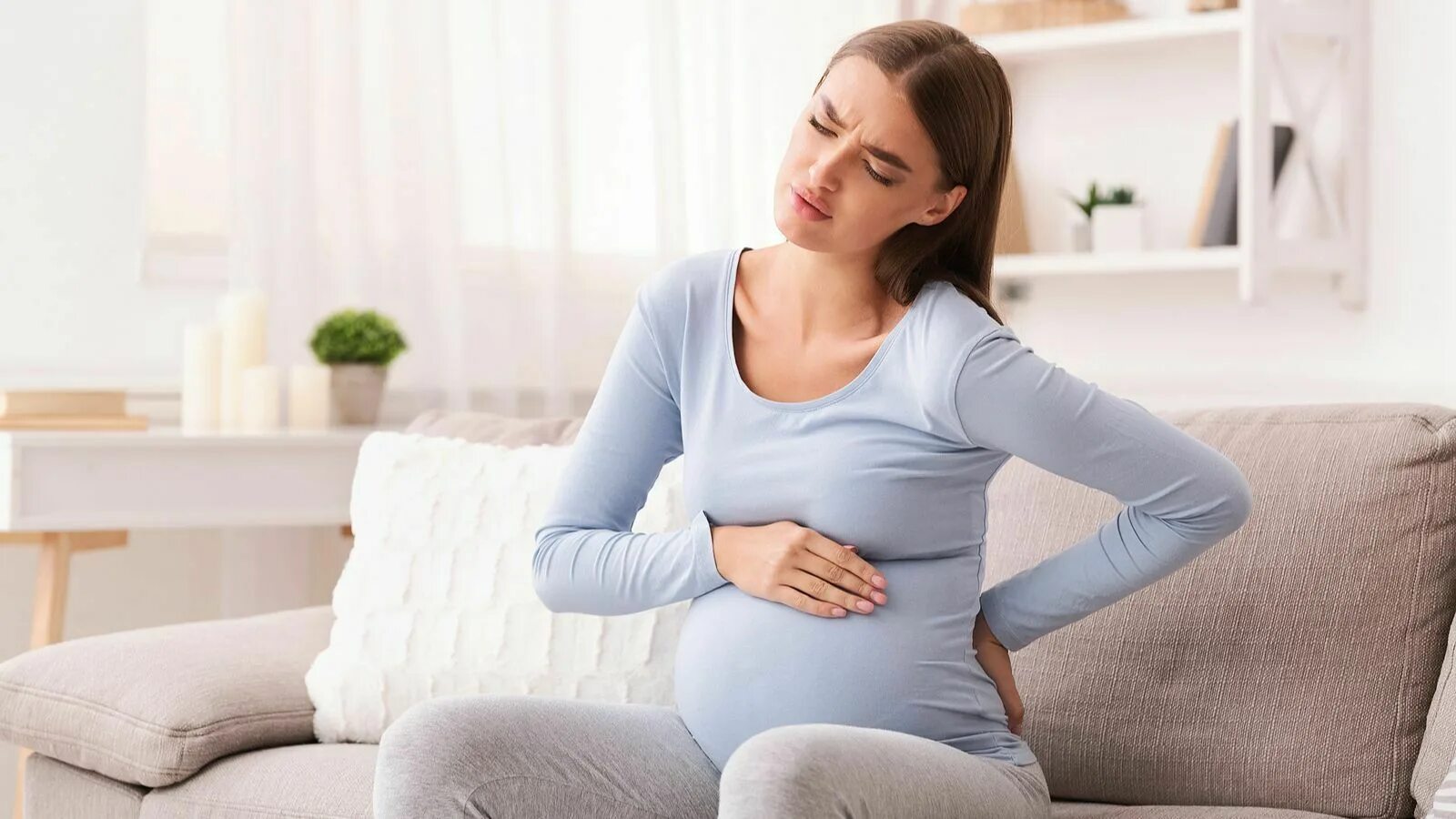 Болит низ спины беременность. У беременной болит спина. Беременность болит.
