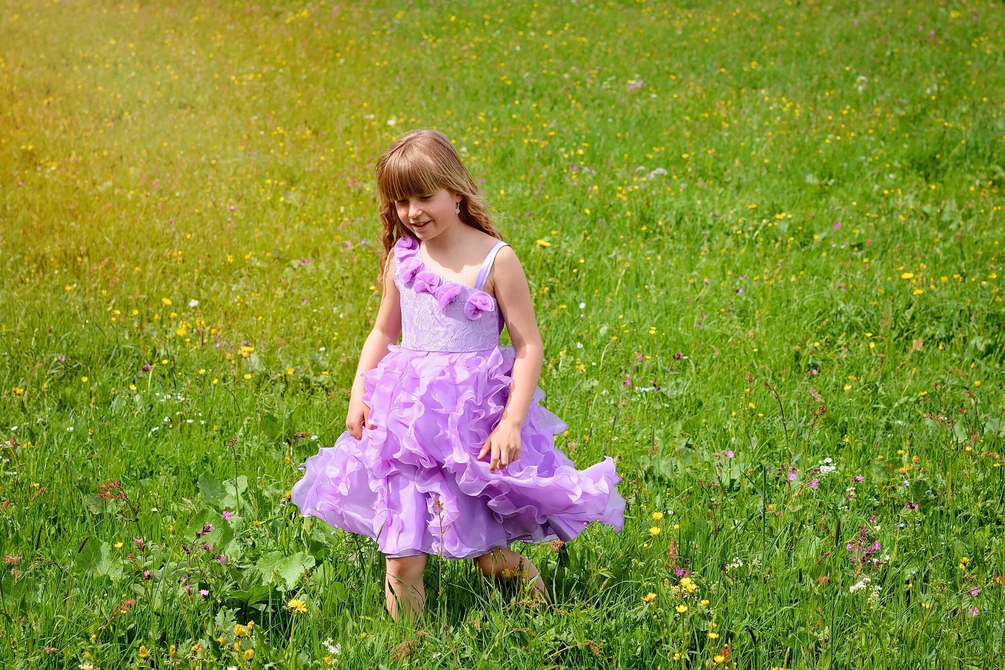 Где девочка. Маленькая девочка в сиреневом платье. Девочка в платье на лугу. Девочка радостная на лужайке. Девочка на лужайке фото.