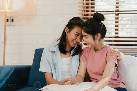 Young Lesbian lgbtq Asian women couple hug and kiss at home. 