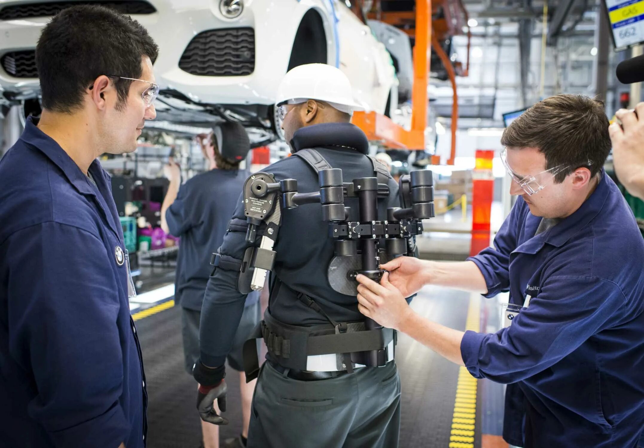 Экзоскелет на BMW. Экзоскелет на заводе. Рабочий на заводе. Промышленный экзоскелет. Factory device