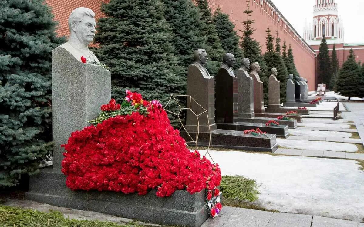 Russian woman puts flowers in Stalin's grave and speaks to. Flickr