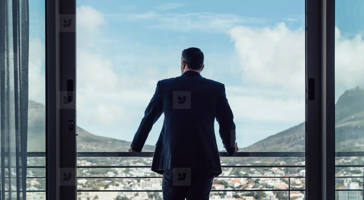 Stay standing. Man on balcony. Man in a Suit balcony. She Stood on the balcony. Man overlooking City.