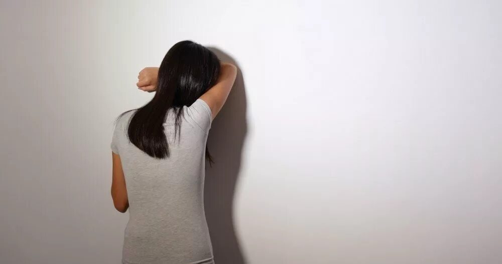 Is against the wall. Girl leaning against the wall. the girl presses against the wall. lean against the wall. model veronica shutterstock.