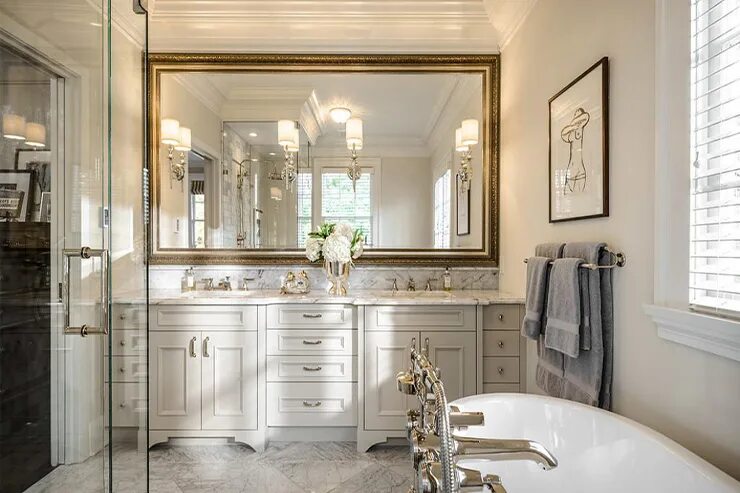 light colored marble and a built in mirrored vanity and mirrors on three sides B