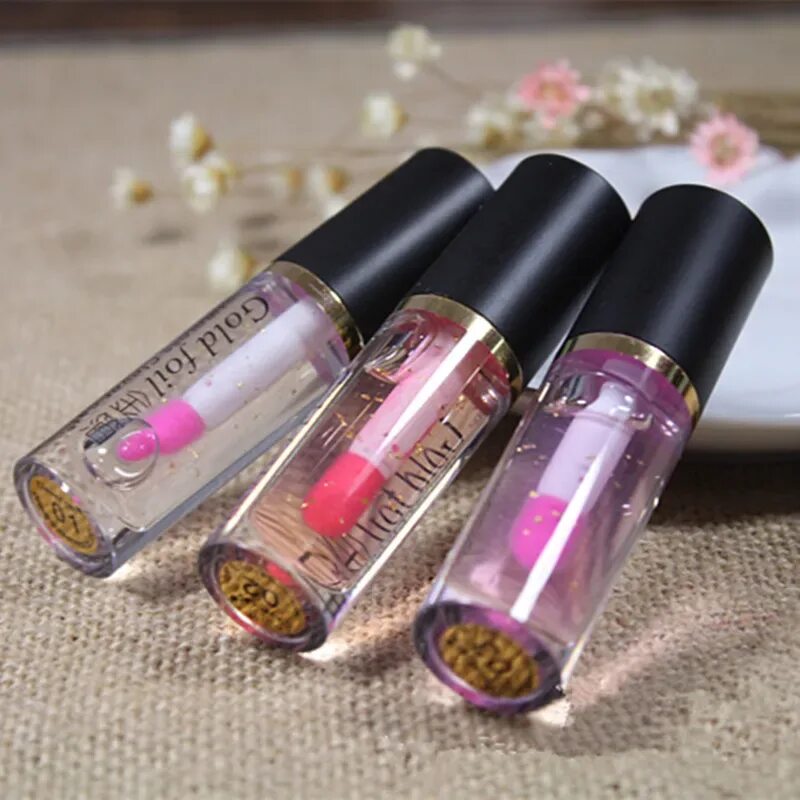 Популярный блеск для губ. Блеск Kiss Beauty 24k Gold Magic Lip Oil. Губы с блеском прозрачным. Блеск для Гуд прозрачные. Прозрачная помада с блёстками.