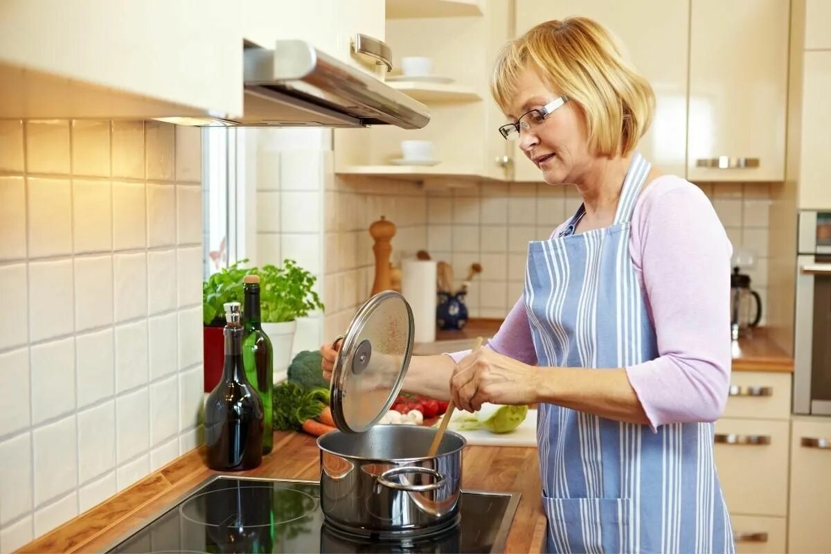 Женщина на кухне. Мама на кухне. Хозяйка на кухне. Готовка на кухне. Домработница готовит