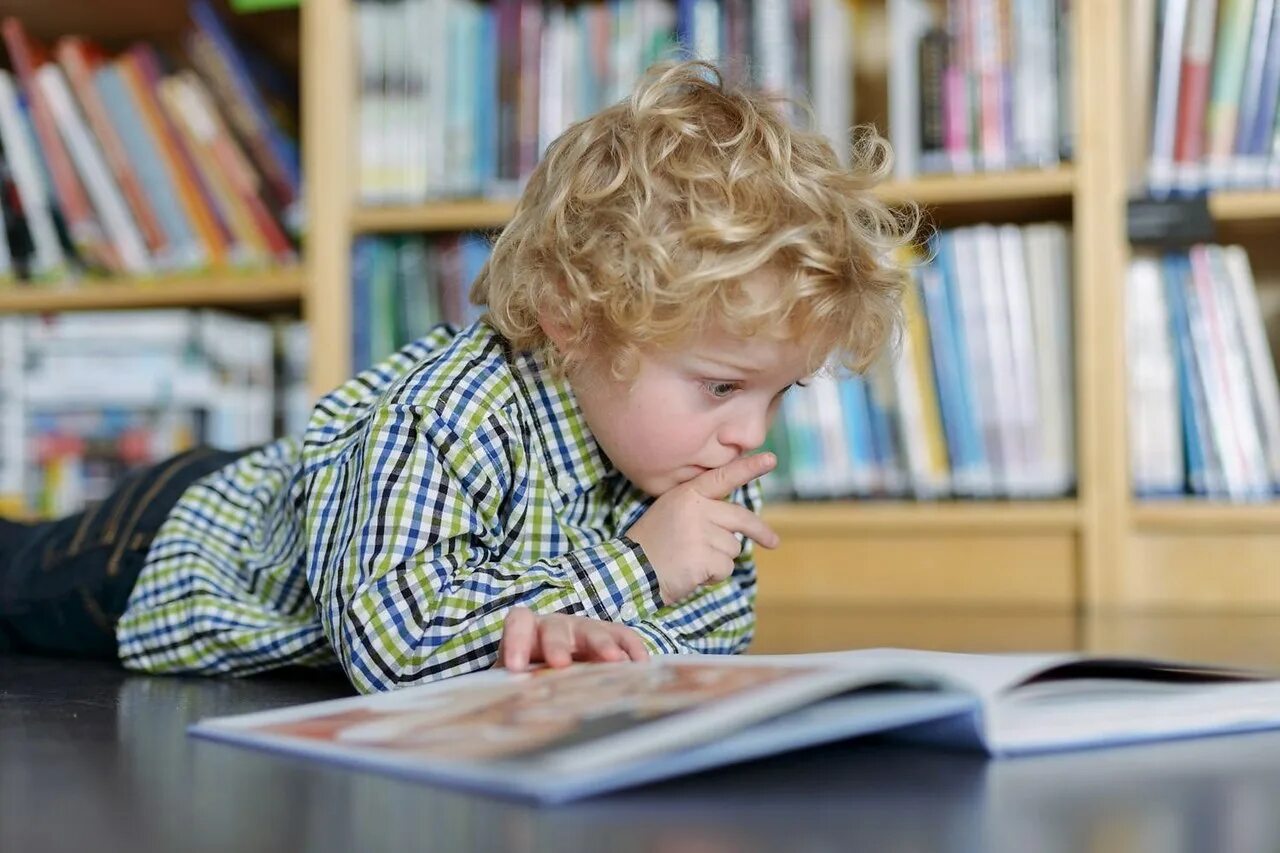 Дети читают. Чтение для детей. Книги для детей. Мальчик в библиотеке.