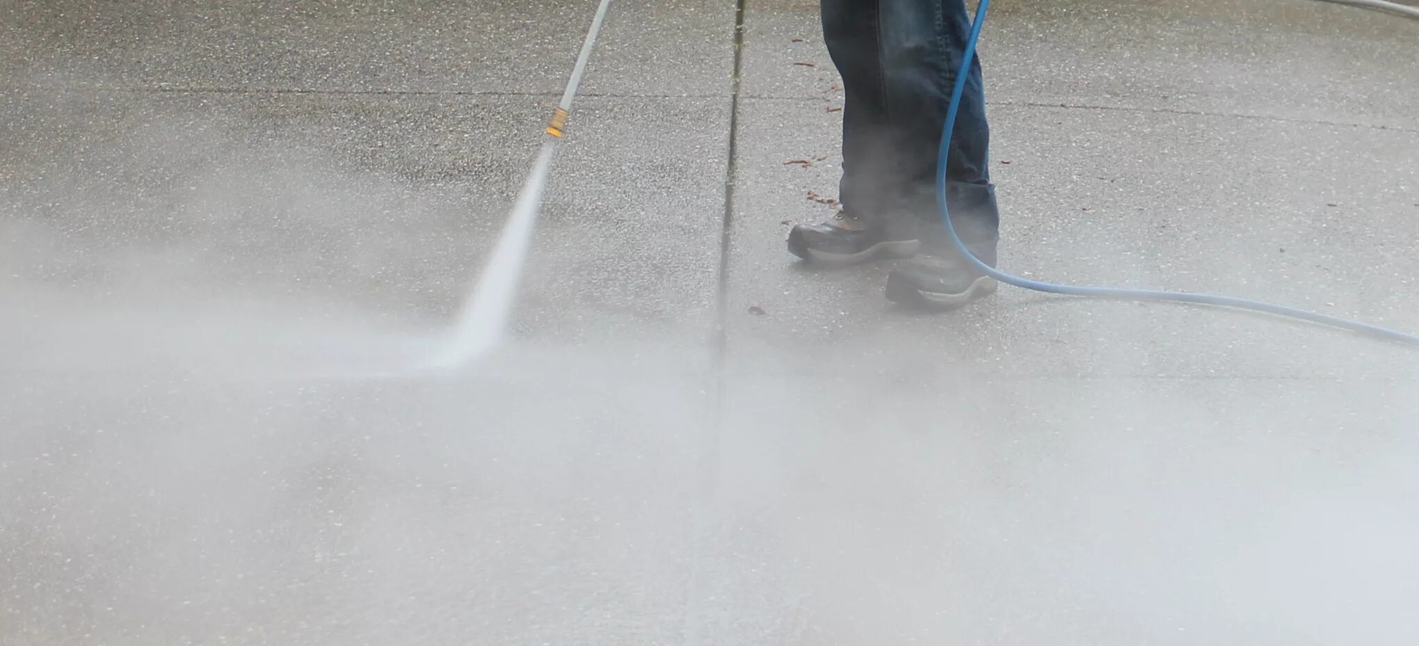 Water from a High Pressure Washer. Pressure washing Run. Pro Pressure Cleaning & Concrete Restoration. Washing of Heavy Equipment.