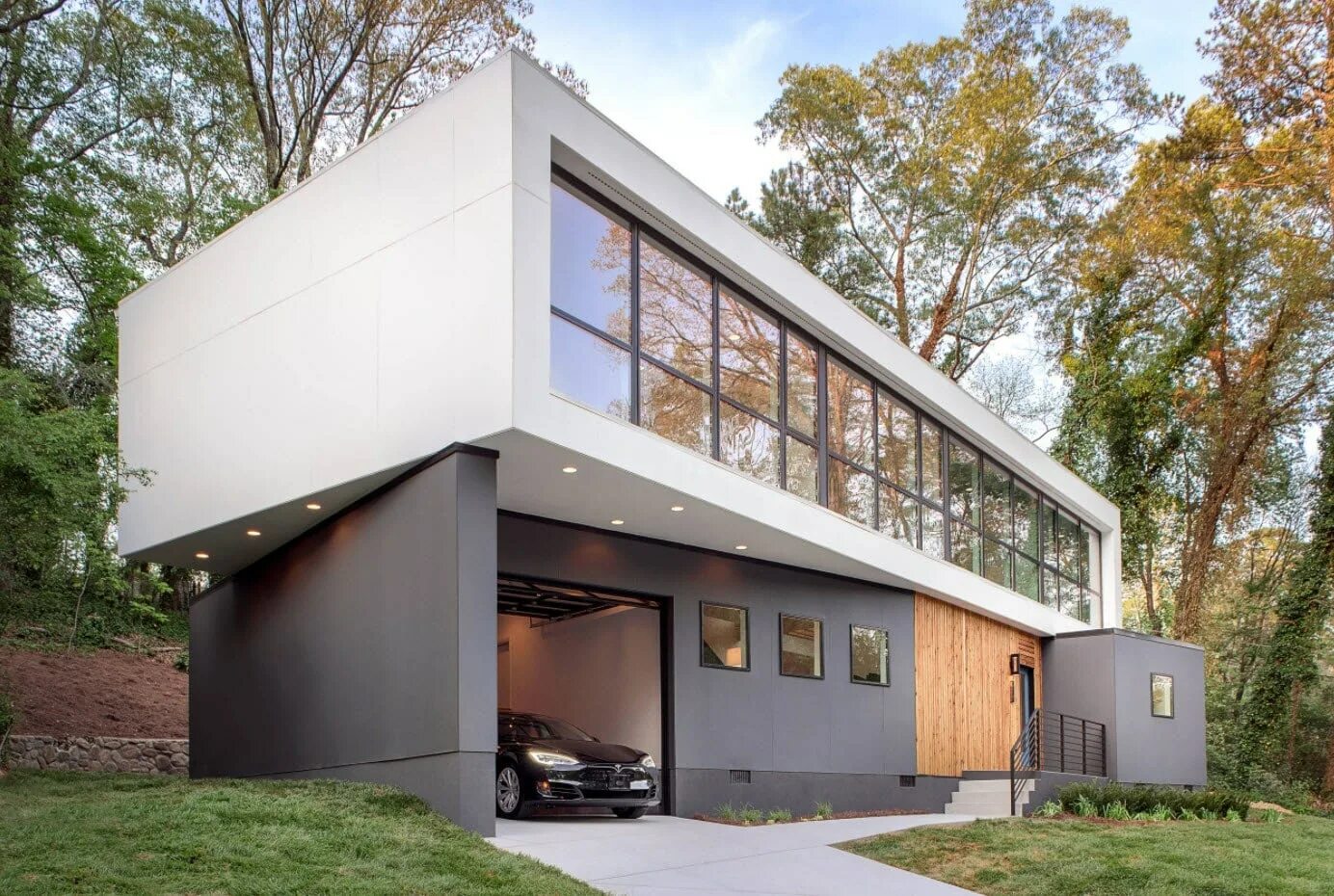 Гараж под жилым домом. Двухэтажный гараж. Двухэтажный гараж в современном стиле. Дом с гаражом на первом этаже. Жилой дом из гаража.