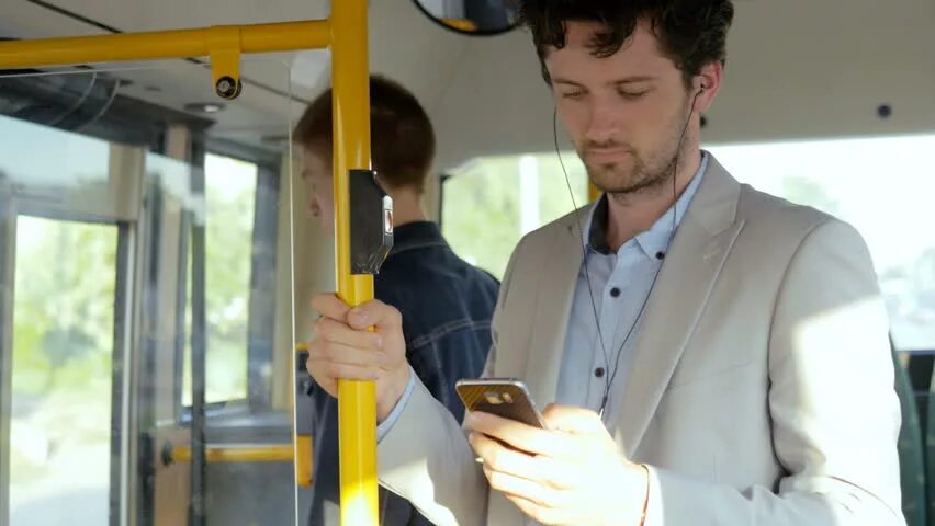 They go to work by bus. Man in bus. three men in the bus фото. bus for workers. phone bus.