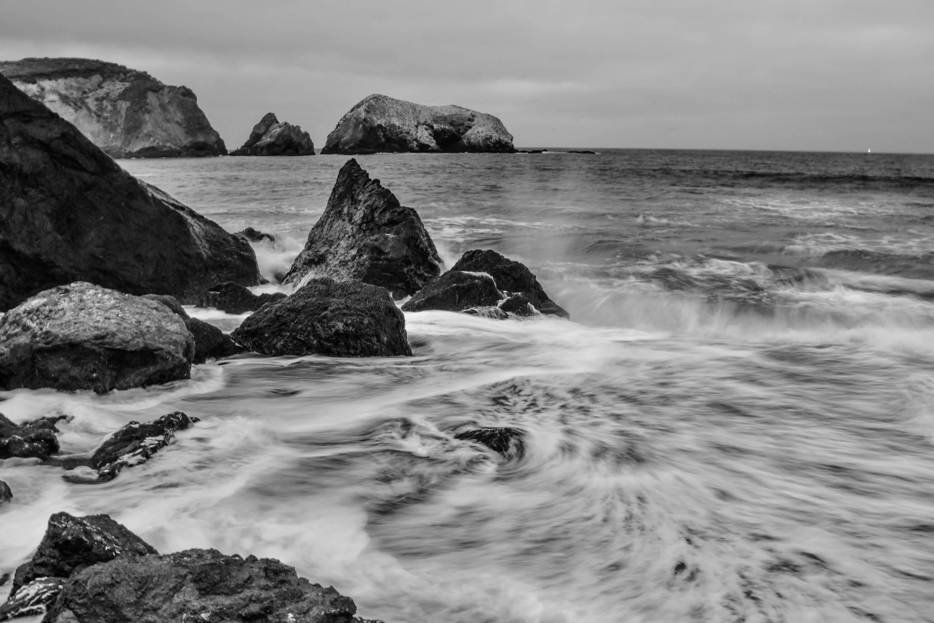 Черно белый океан. Море черно белое. Пейзаж море. Каменистый пляж.