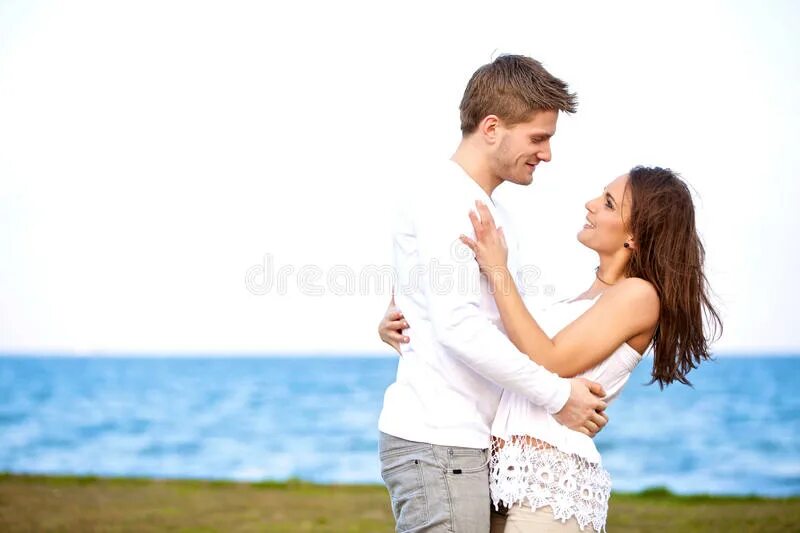Looking at each other. Couple looking each other. Happy couple joking with each other. Couple Wrapped around each other.