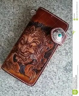 Photo about Hand carved, painted and tooled biker wallet in Japanese tradit...